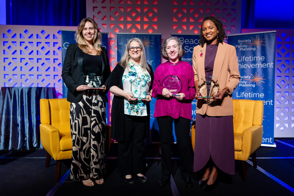 2026 award winners stand on a stage at the Society's Annual Meeting. From left to right are Dana Johnson, Ronna Popkin, Mary Fjerstad, and Whitney Rice.